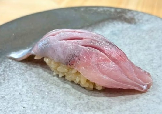 A photo of Roughear scad (Oakamuro) nigiri sushi
