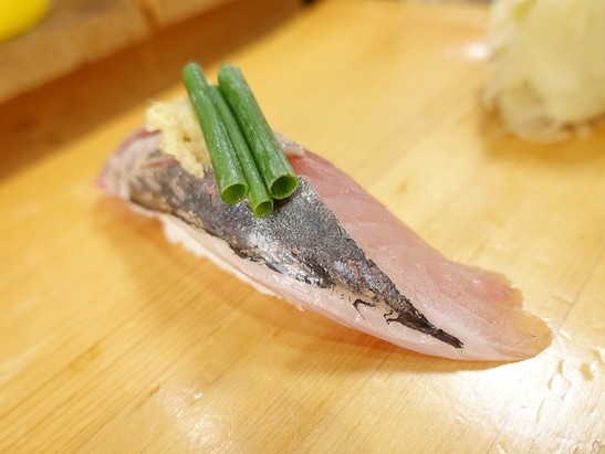 A photo of Aiburi (Blackbanded trevally) nigiri sushi