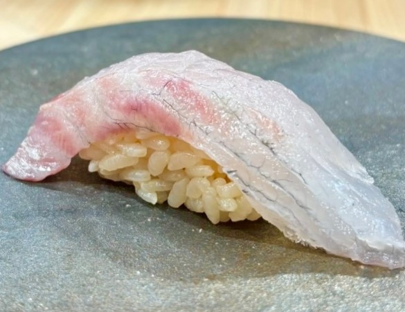 A photo of Japanese large-eye bream (Shirodai) nigiri sushi