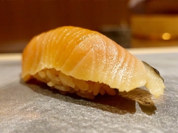 A photo of Cherry salmon nigiri sushi