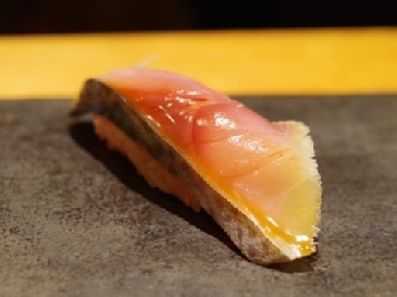 A photo of Spotted chub mackerel nigiri