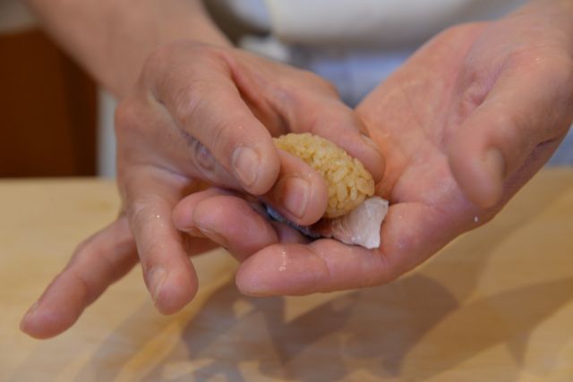 A photo of making nigiri sushi