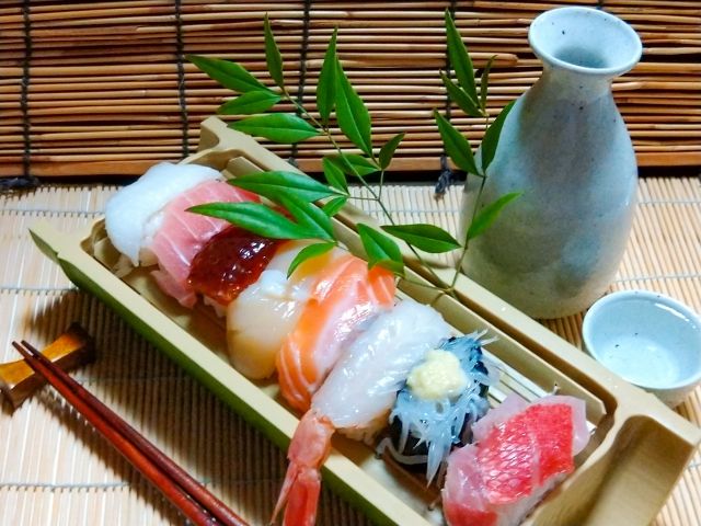 A photo of sake and nigiri sushi