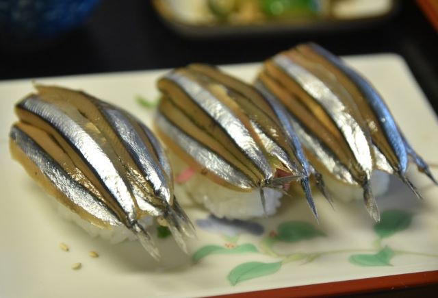 a photo of Kibinago nigiri sushi