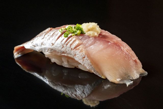 A photo of Aji nigiri