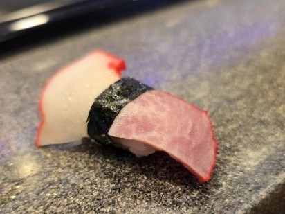 A photo of Whale bacon nigiri sushi